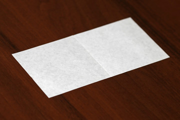 White paper on wood background