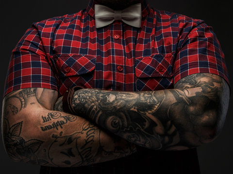 Hipster in red shirt and tattooes.