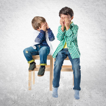 Kids Covering His Eyes Over White Background