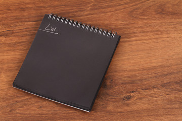 The Balck Notepad or black reminder on wood
