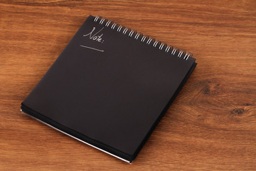 The Balck Notepad or black reminder on wood