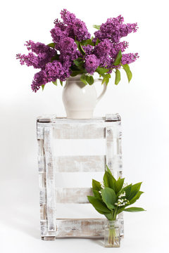 lilacs and lilies of the valley on a wooden crate - decoration