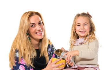 Mother and daughter playing with cup of coffee