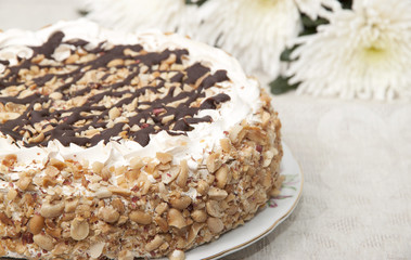 Cake with honey shortcakes, curd cream with nuts and chocolate.
