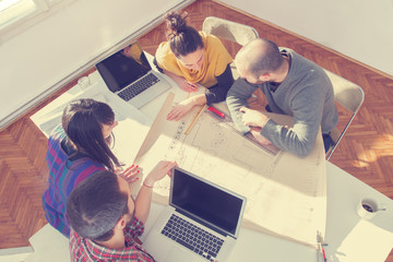 Young group of people/architects discussing business plans.