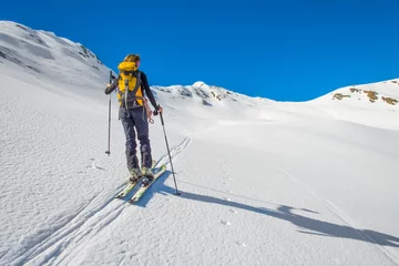 Fotobehang Girl makes ski mountaineering, Randonnee ski trails © michelangeloop