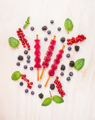 Fototapeta na wymiar Berries Ice cream pops with summer berries, top view