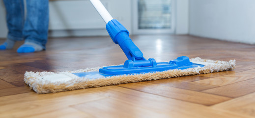 Mop cleaning a wooden floor 