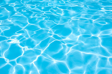 Naklejka na ściany i meble Bright water surface in swimming pool