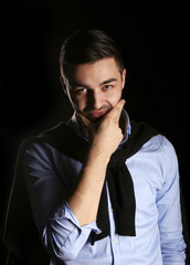 young fashion man model on black background