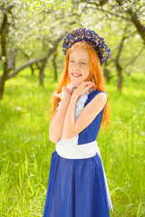 red-haired girl in a sunny garden