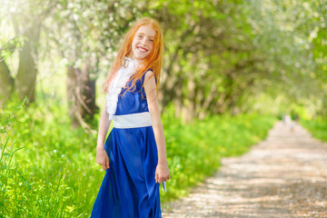 red-haired girl in a sunny garden