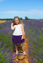 Cute little girl walking on a lavender field