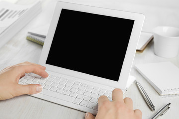 Fototapeta na wymiar Rear view of employee hands working on tablet computer keyboard