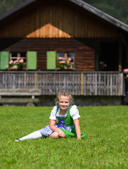 Fototapeta premium Llittle girl wearing a traditional Bavarian dress dirndl