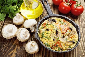Omelet with mushrooms and tomatoes. Frittata