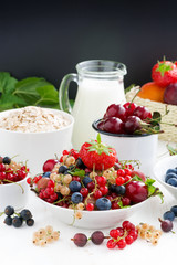 fresh berries, fruit, cereal and milk. black background for text