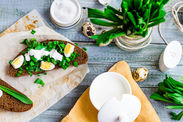 rye bread with wild garlic, sour cream and quail eggs