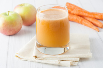 apple carrot juice in a glass on whte background