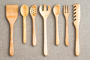 Row of assorted wooden kitchen utensils