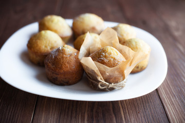 Homemade muffins in plate on wood table