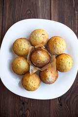 Homemade muffins in plate on wood table
