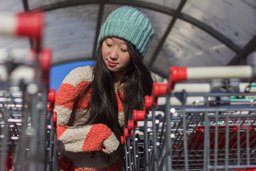 portrait of stylish Asian girls near small cart