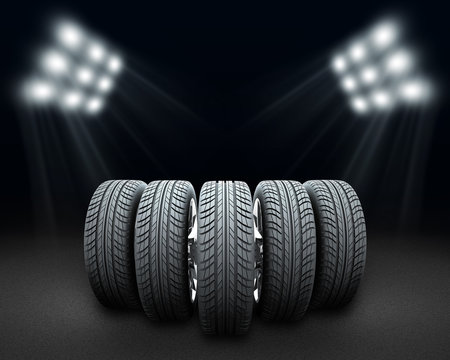 Wedge of new car wheels. Dark background with spotlight