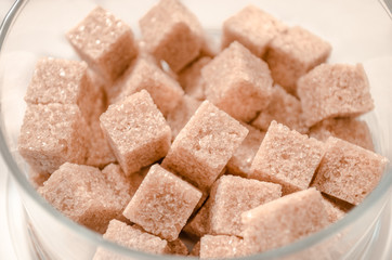 Brown cane sugar cubes isolated on white background