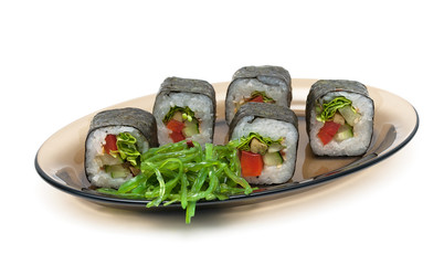 rolls and chuka salad on a plate on a white background
