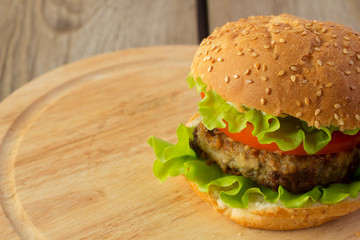 Burger on wooden plate right