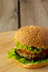 Burger on wooden plate