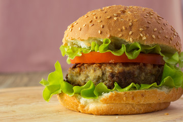 Burger on wooden plate