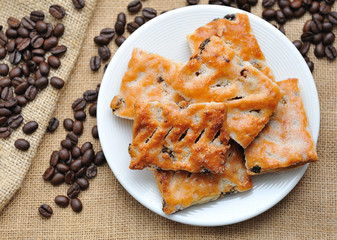 Cookies in plate  with coffee beans on canvas.