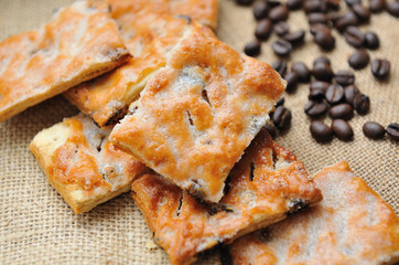 Cookies   with coffee beans on brown canvas.