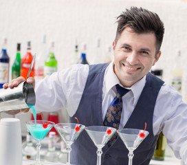 bartender pouring a cocktail drink