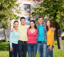 Fototapeta na wymiar group of smiling teenagers over campus background
