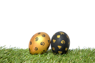 Gold and black handmade easter eggs on green grass