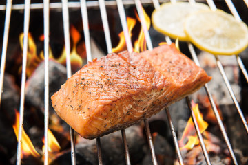 Grilled salmon with lemon on the flaming