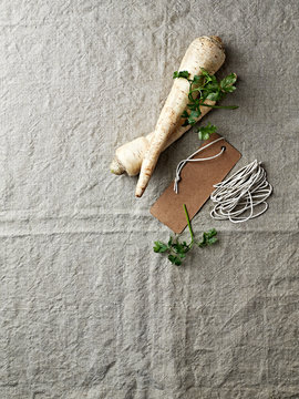 Parsley roots and  paper label on a linen cloth