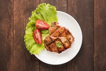 Grilled steak with vegetables on a dish.
