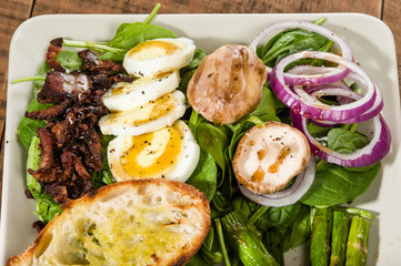Spinach and egg salad with bacon bits