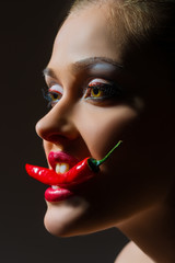 girl with peppers in the teeth
