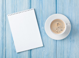 Coffee cup and blank notepad