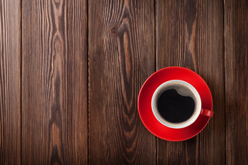 Coffee cup on wooden table background