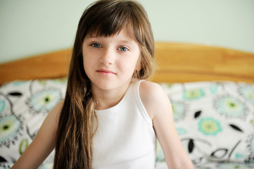 Adorable little girl awaked up in her bed