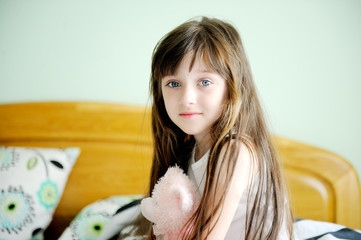Adorable little girl awaked up in her bed © Alinute