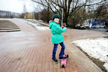 Kid girl on a scooter
