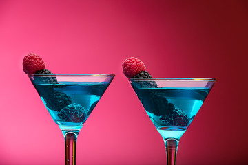 Colorful cocktails garnished with berries