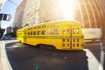 Fototapeta na wymiar Vintage tram driving in downtown San Francisco at sunset